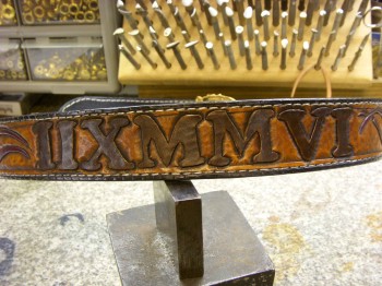 belts lend thelselves to long thin graphics - something vertical like a roman numeral is tough
